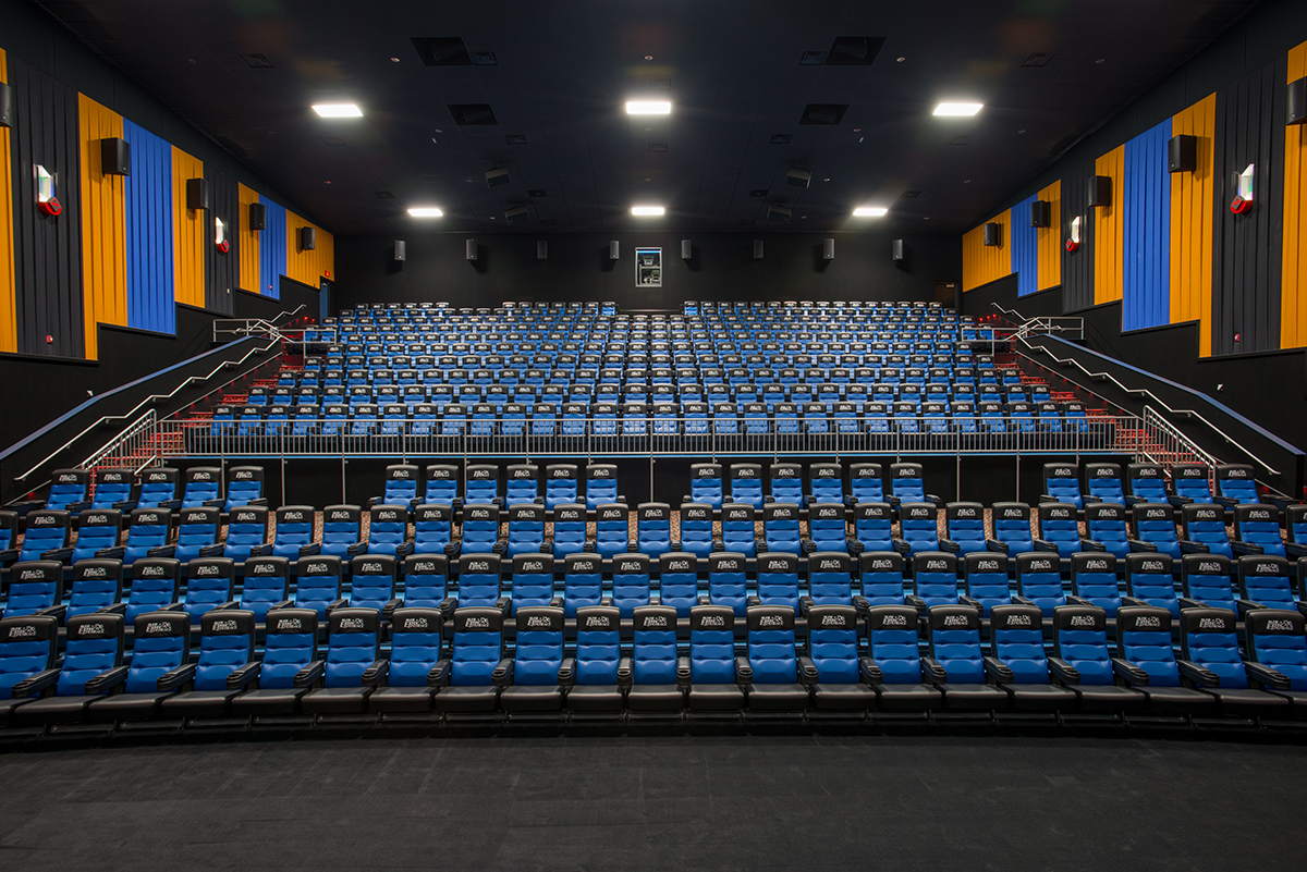 A wide view looking up at custom cinema seating for a stadium-style auditorium.