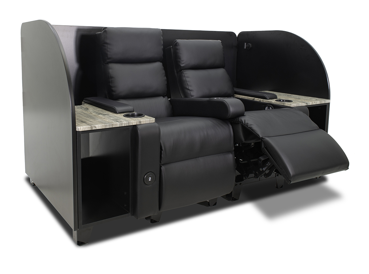 A black cinema recliner with heated seats, side tables, personal storage, and privacy panels.