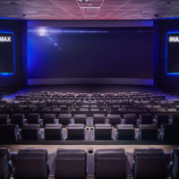 A view of an IMAX laser auditorium from the back row of seating.